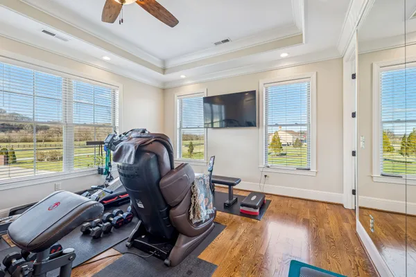a living room with furniture and a wooden floor