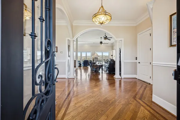 a view of a livingroom with furniture wooden floor a chandelier