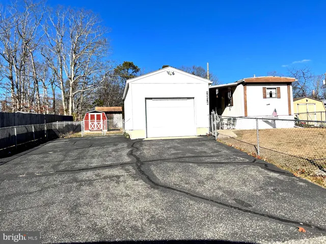 a bed sitting in a kitchen next to a cabinet
