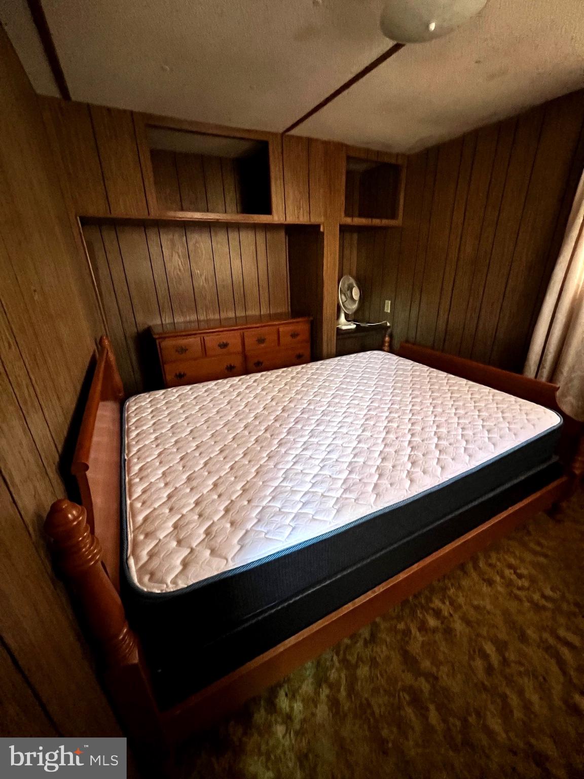 1314 Spring Garden Road Millville, NJ 08332 - Photo 2 of 10 a bed sitting in a kitchen next to a cabinet