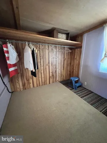 a view of a livingroom with furniture and a window