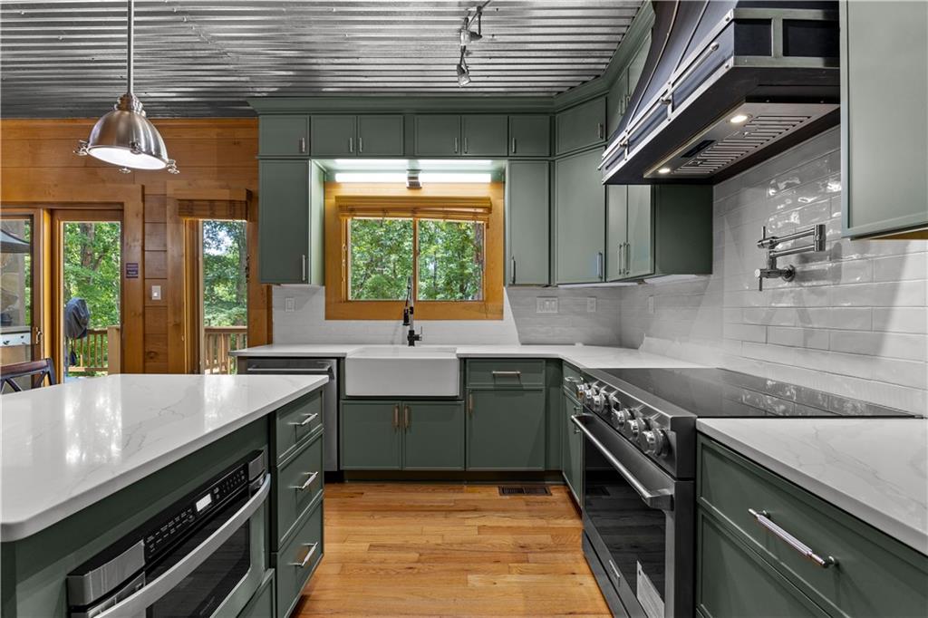 394 Ferrell-Tatum Road LaGrange, GA 30240 - Photo 17 of 68 a kitchen with stainless steel appliances granite countertop a sink a stove and a wooden floor