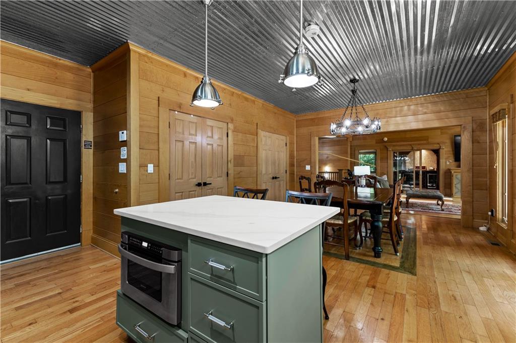 394 Ferrell-Tatum Road LaGrange, GA 30240 - Photo 18 of 68 a room with stainless steel appliances kitchen island granite countertop a table chairs and a wooden floor