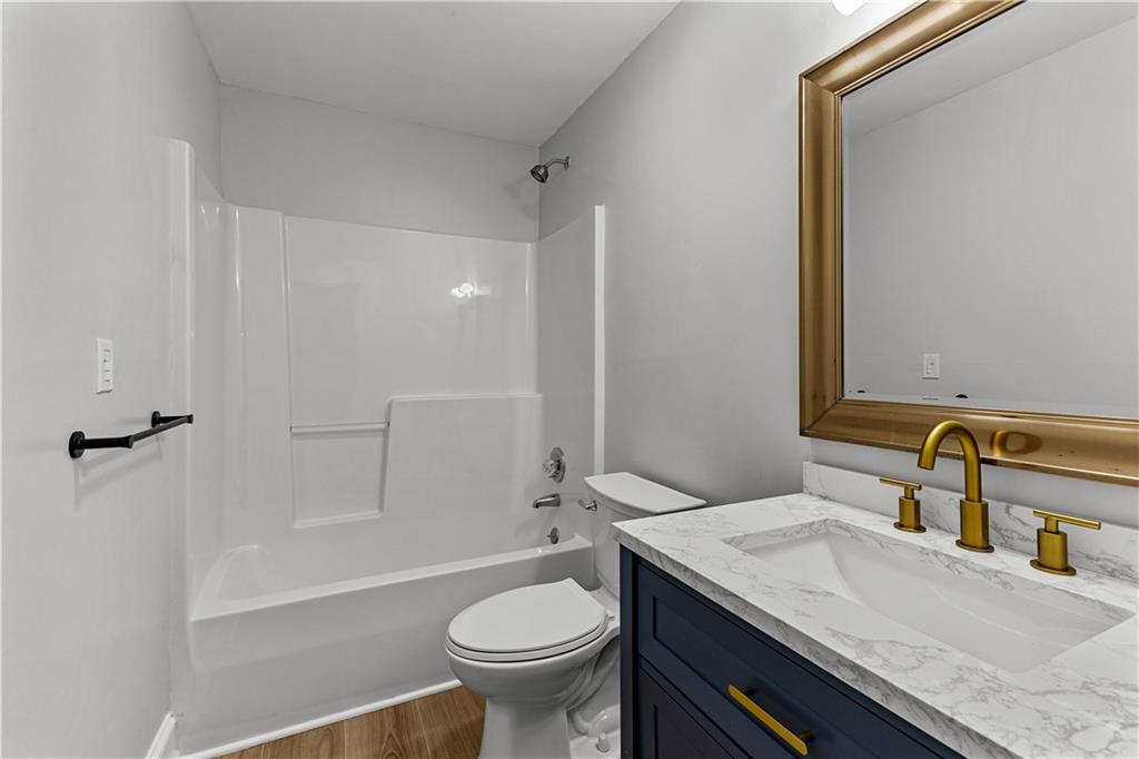 394 Ferrell-Tatum Road LaGrange, GA 30240 - Photo 51 of 68 a bathroom with a granite countertop sink and a mirror