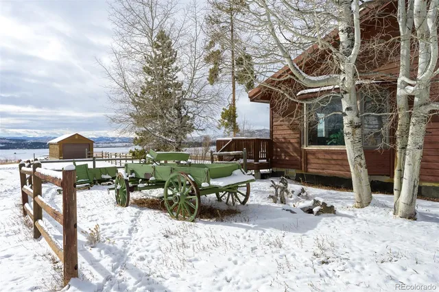 a view of a patio with a table and chairs under an umbrella
