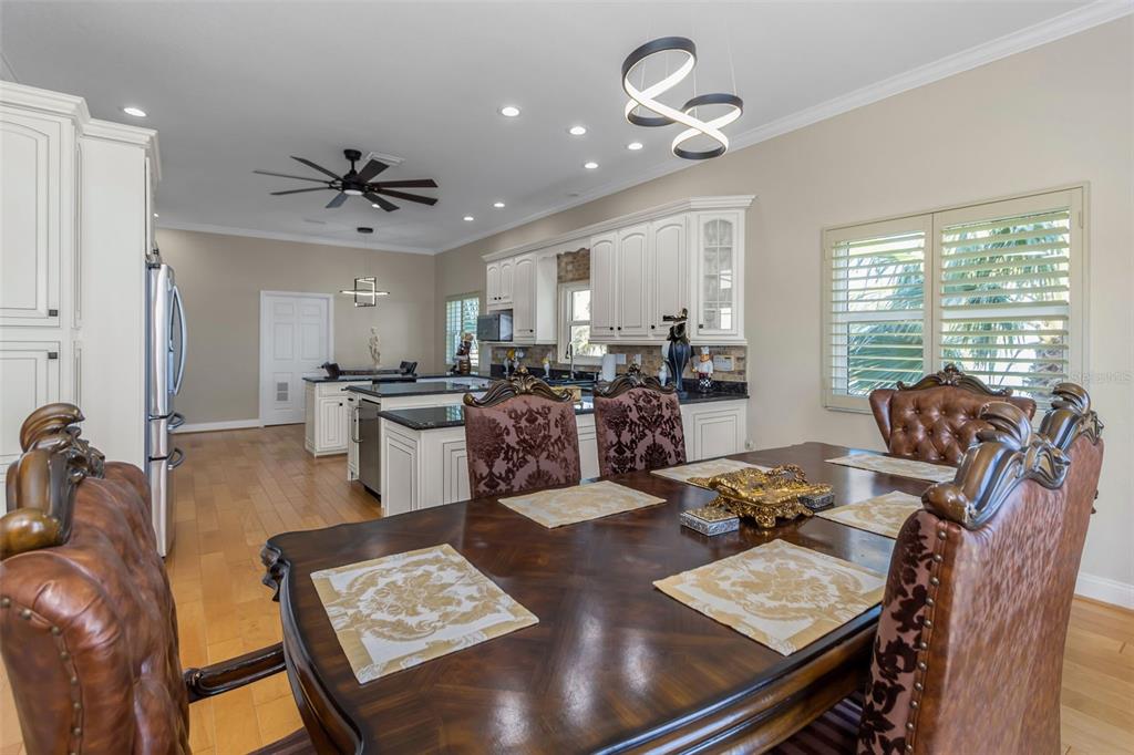 4613 Harborpointe Drive Port Richey, FL 34668 - Photo 15 of 21 a view of a dining room and livingroom with furniture wooden floor a chandelier