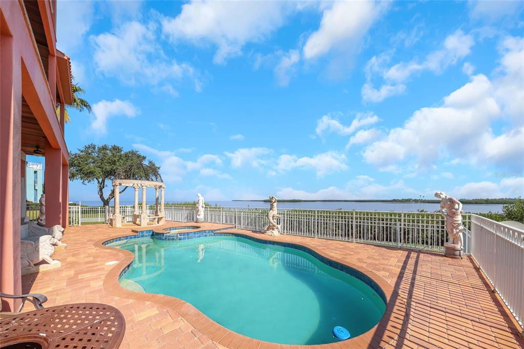 4613 Harborpointe Drive Port Richey, FL 34668 - Photo 3 of 21 a view of a swimming pool with a patio