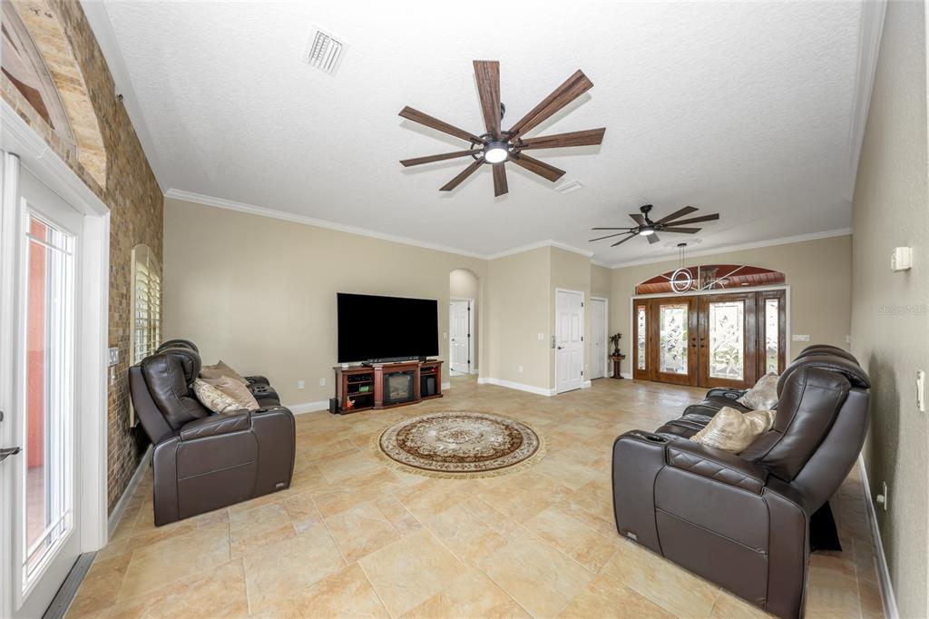 4613 Harborpointe Drive Port Richey, FL 34668 - Photo 8 of 21 a living room with furniture and a flat screen tv