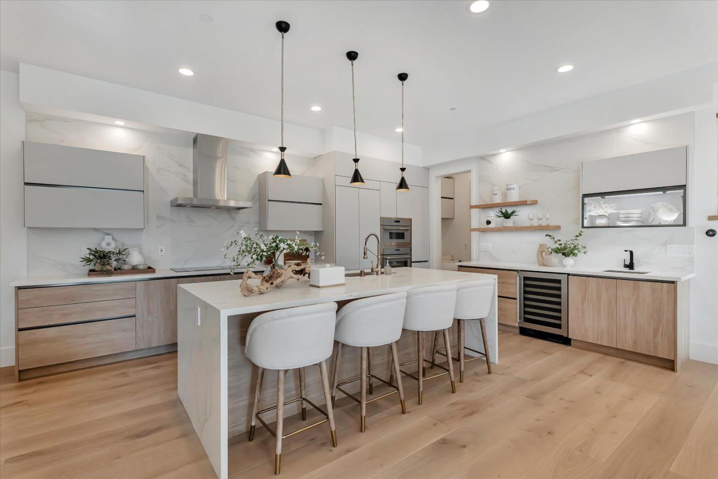 a kitchen with kitchen island granite countertop a white cabinets and chairs