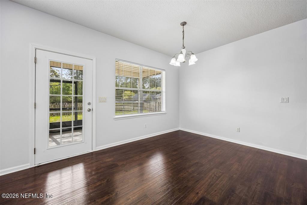 96204 Coral Reef Road Yulee, FL 32097 - Photo 11 of 40 wooden floor in an empty room with a window