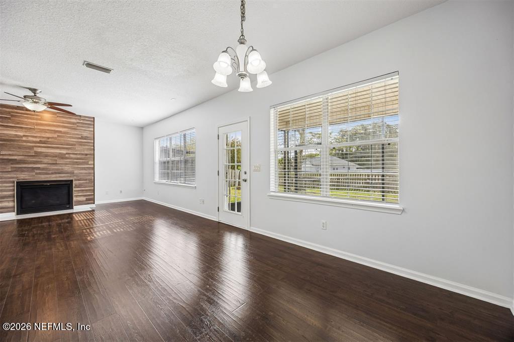 96204 Coral Reef Road Yulee, FL 32097 - Photo 12 of 40 a view of an empty room with wooden floor and a window