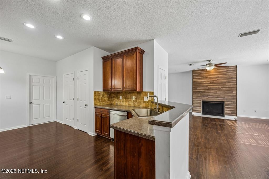 96204 Coral Reef Road Yulee, FL 32097 - Photo 16 of 40 a kitchen with a stove and a wooden floors