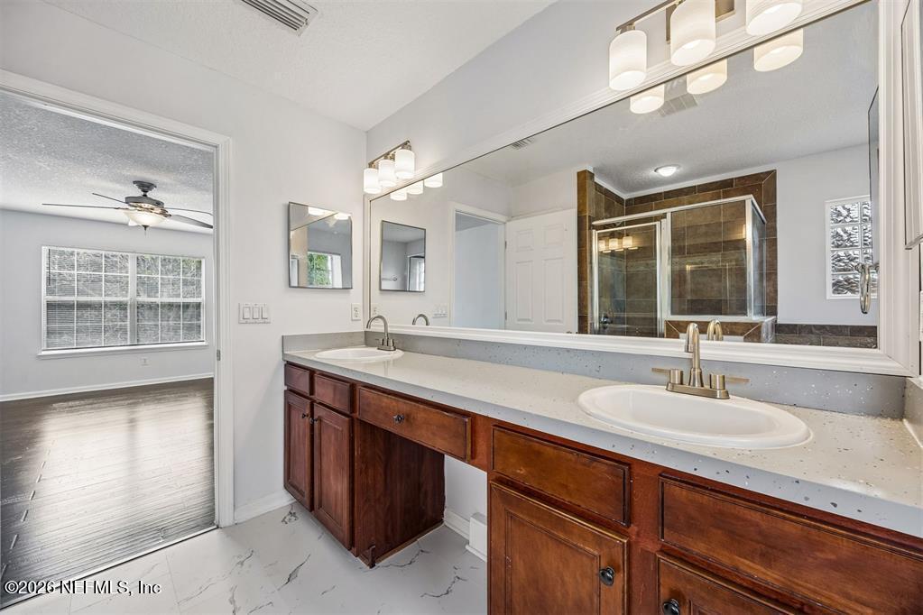 96204 Coral Reef Road Yulee, FL 32097 - Photo 23 of 40 a bathroom with a sink and a mirror