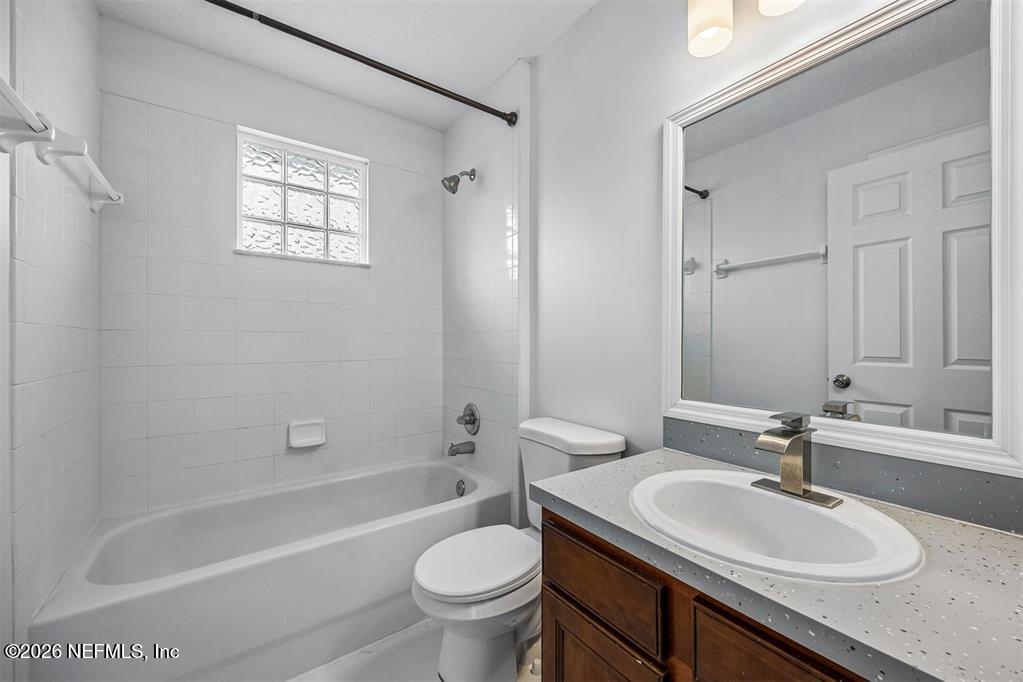 96204 Coral Reef Road Yulee, FL 32097 - Photo 29 of 40 a bathroom with a granite countertop sink toilet and shower