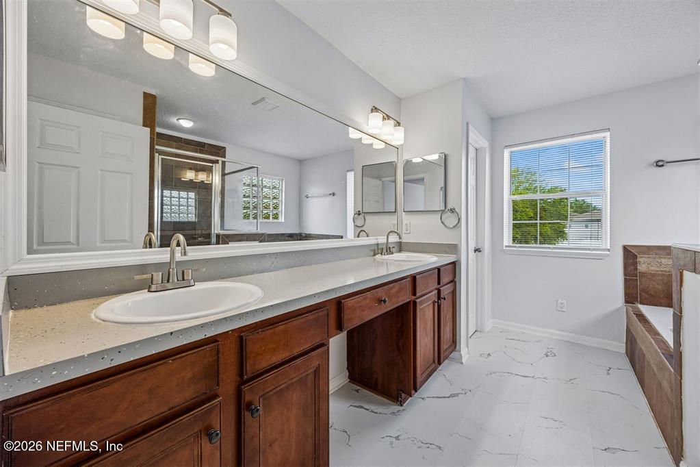 96204 Coral Reef Road Yulee, FL 32097 - Photo 4 of 40 a bathroom with a sink and a mirror
