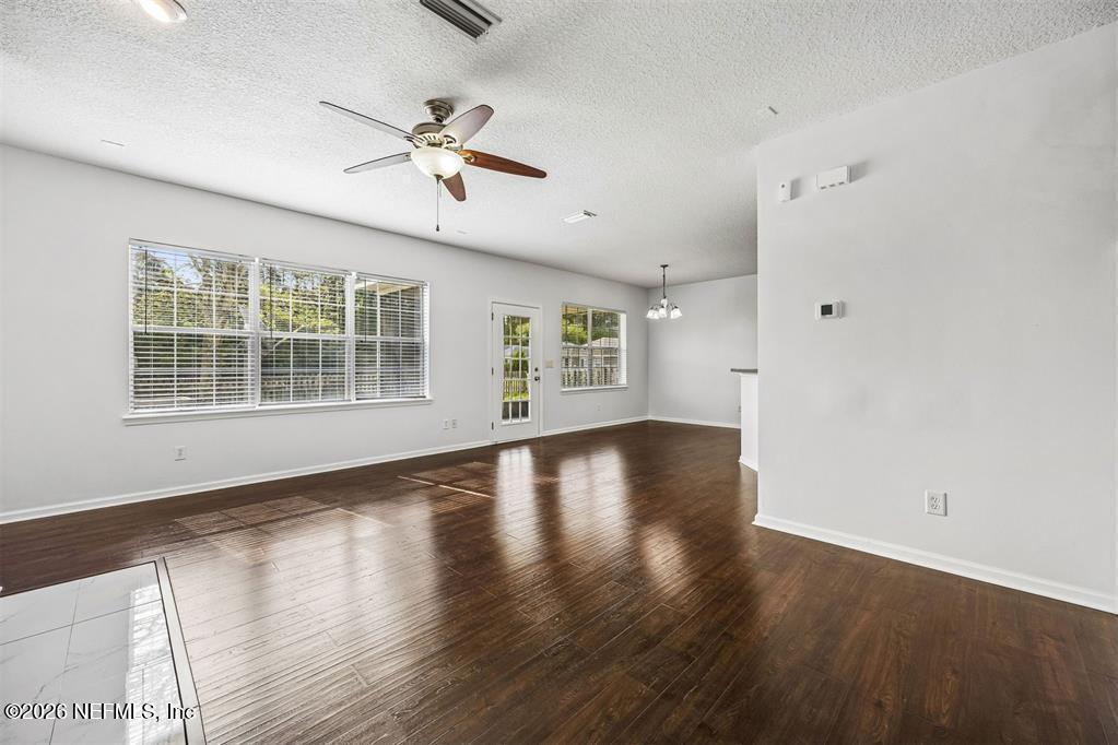 96204 Coral Reef Road Yulee, FL 32097 - Photo 8 of 40 wooden floor in an empty room with a window