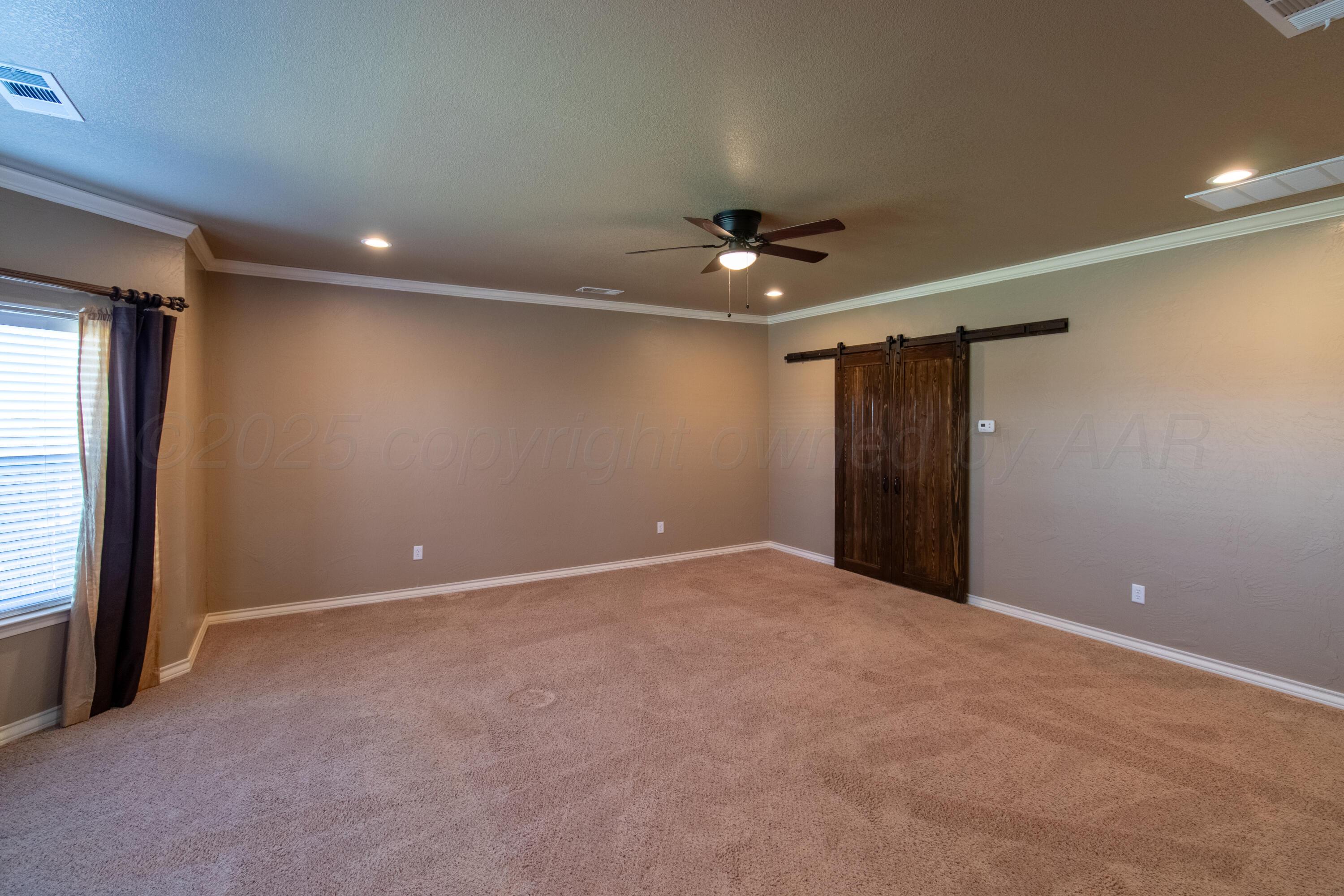 19100 Stone Creek Road Amarillo, TX 79124 - Photo 13 of 49 Primary bedroom with custom barn doors