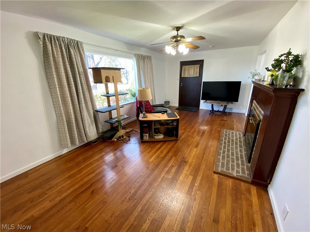 517 Darrow Road Akron, OH 44305 - Photo 3 of 21 LIVING ROOM WITH PICTURE WINDOW AND REFINISHED HARDWOOD FLOORS & WOOD BURNING FIREPLACE.