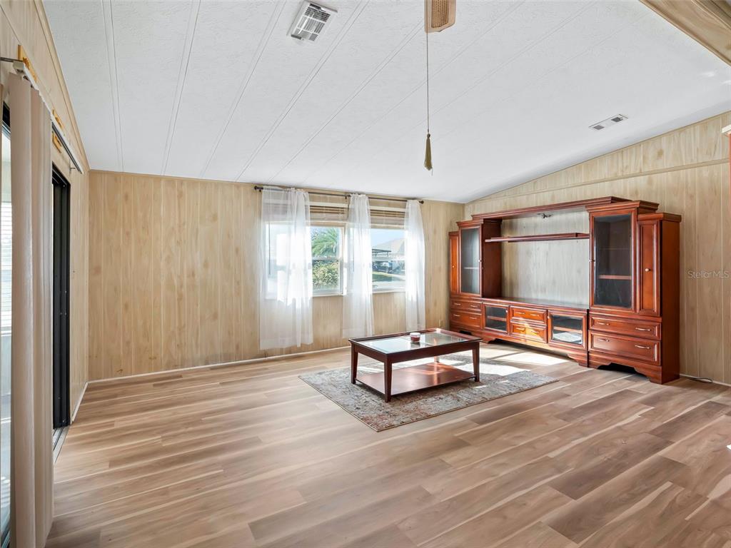1102 Dustin Drive The Villages, FL 32159 - Photo 11 of 38 a living room with furniture a flat screen tv and windows
