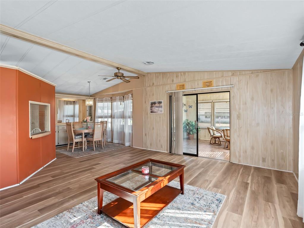 1102 Dustin Drive The Villages, FL 32159 - Photo 12 of 38 a living room with furniture a flat screen tv and a table