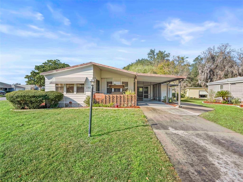 1102 Dustin Drive The Villages, FL 32159 - Photo 2 of 38 front view of a house with a yard