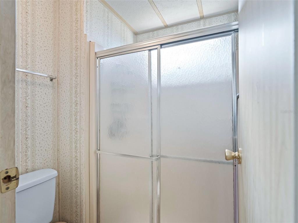 1102 Dustin Drive The Villages, FL 32159 - Photo 23 of 38 a bathroom with a glass shower door