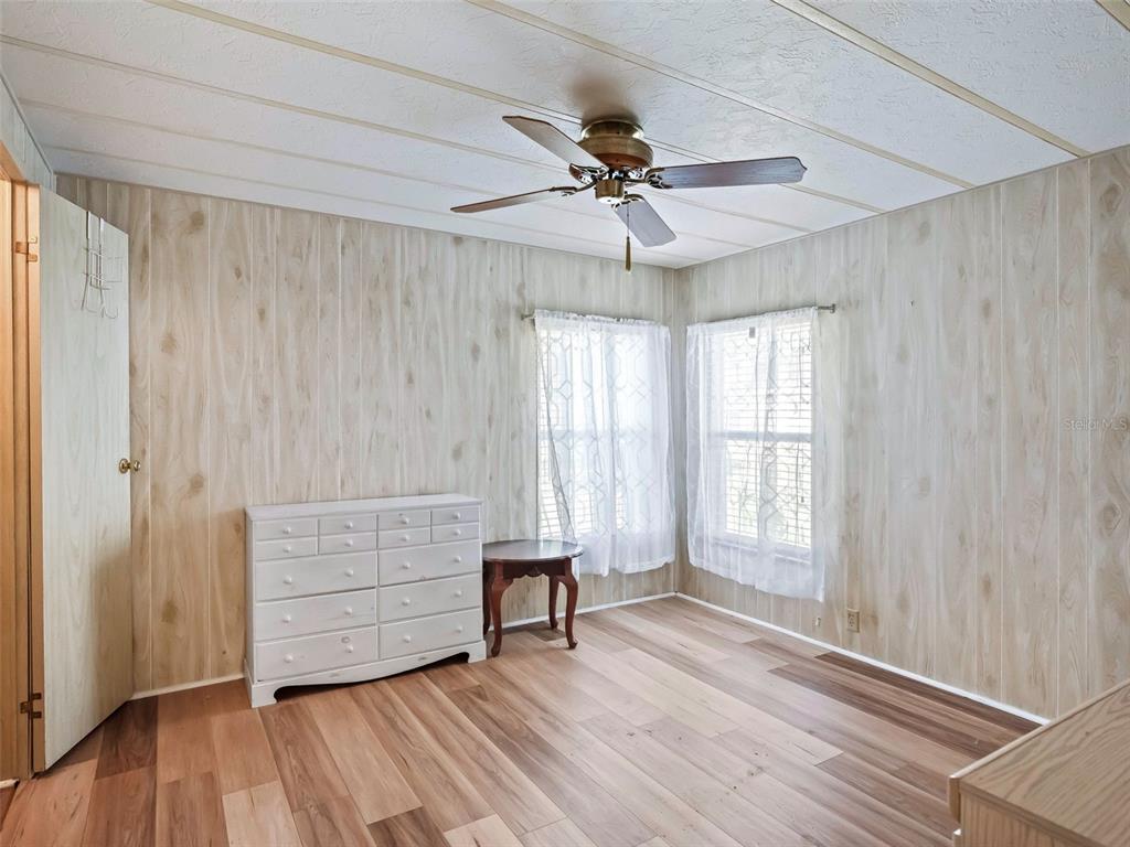1102 Dustin Drive The Villages, FL 32159 - Photo 24 of 38 a view of an empty room with wooden floor and a window
