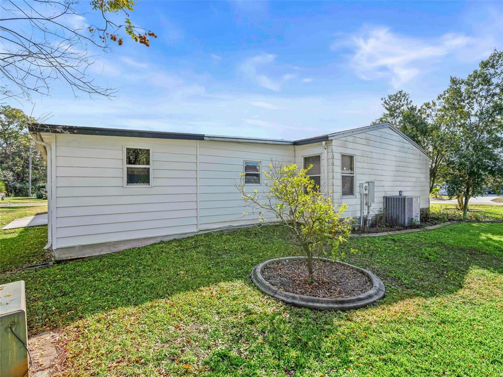 1102 Dustin Drive The Villages, FL 32159 - Photo 30 of 38 a view of a backyard with plants and a garden