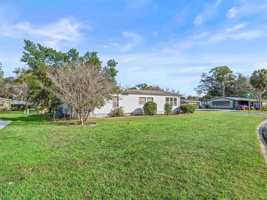 1102 Dustin Drive The Villages, FL 32159 - Photo 31 of 38 a front view of a house with a yard