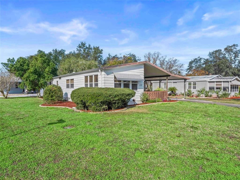 1102 Dustin Drive The Villages, FL 32159 - Photo 37 of 38 a front view of a house with a yard