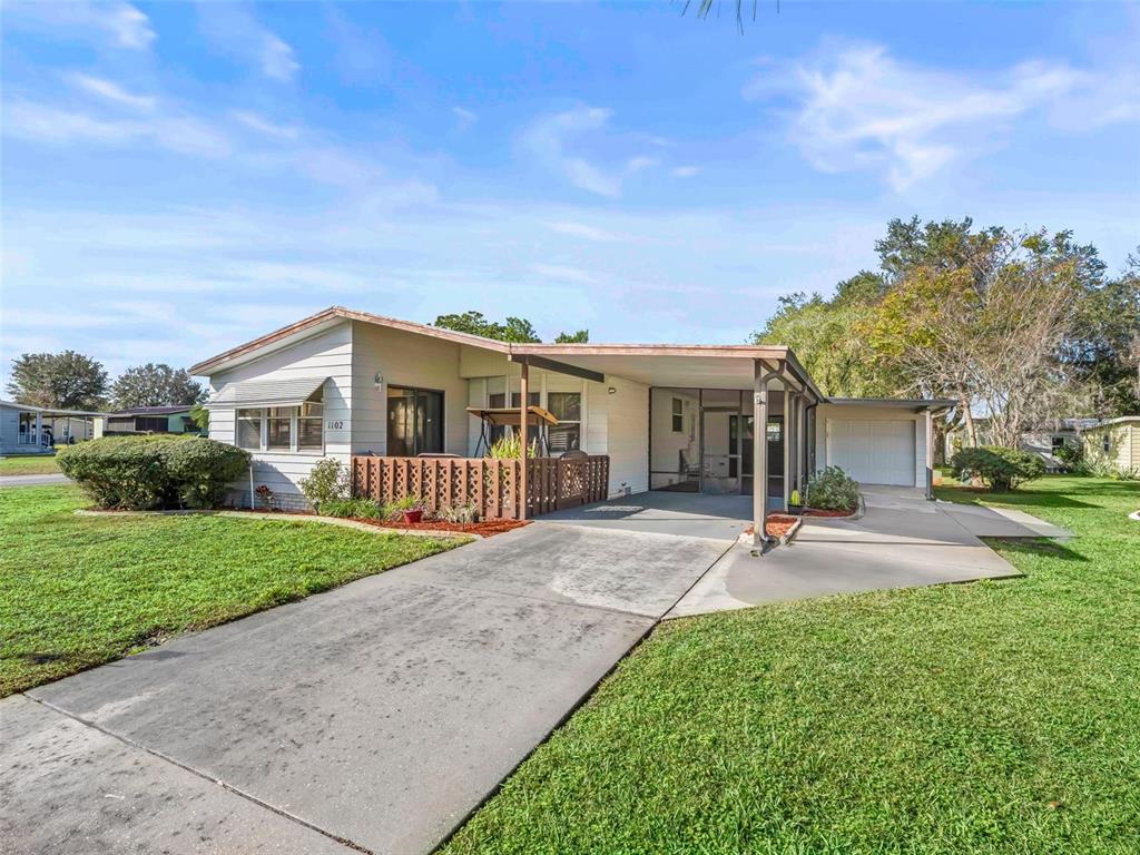 1102 Dustin Drive The Villages, FL 32159 - Photo 38 of 38 a view of a house with a yard and table
