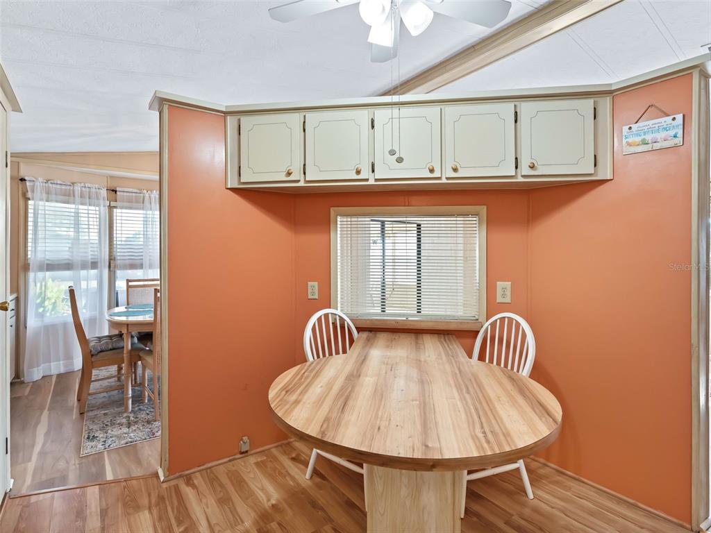 1102 Dustin Drive The Villages, FL 32159 - Photo 10 of 38 a view of a dining room with furniture and wooden floor