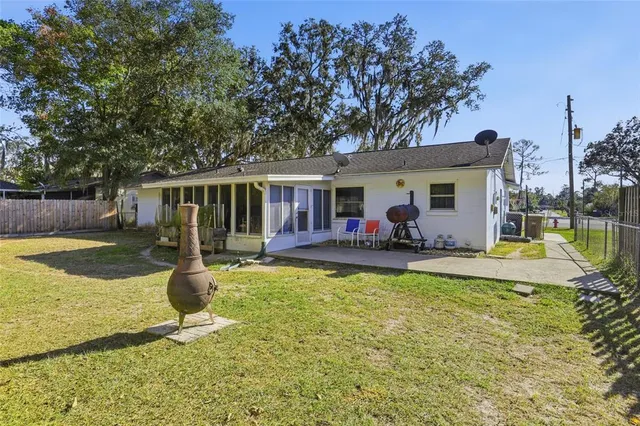 a view of a house with swimming pool and porch with furniture