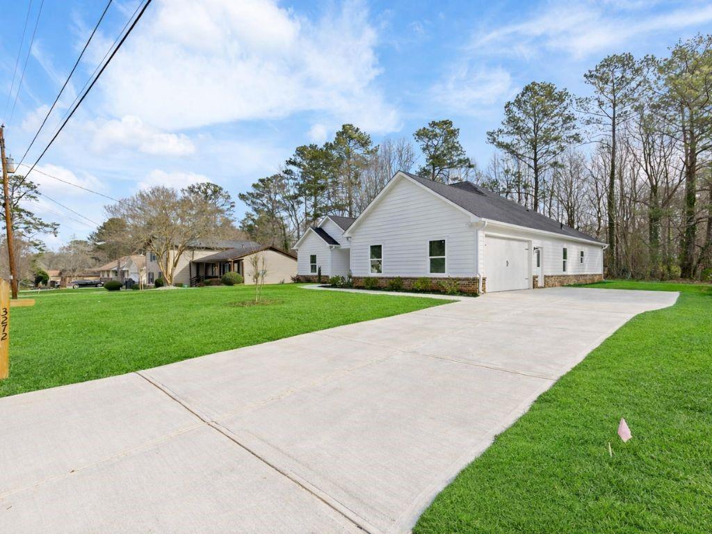 3272 Corktree Trail Lithonia, GA 30038 - Photo 21 of 22 a view of house with a yard and potted plants