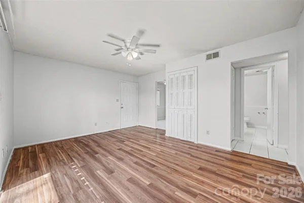 a view of empty room with wooden floor