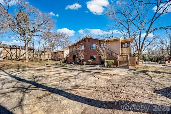 a view of a houses with snow on the road