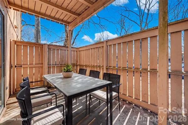 a view of a balcony with furniture and wooden floor