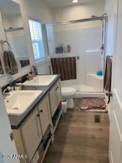 a bathroom with a sink a toilet and shower