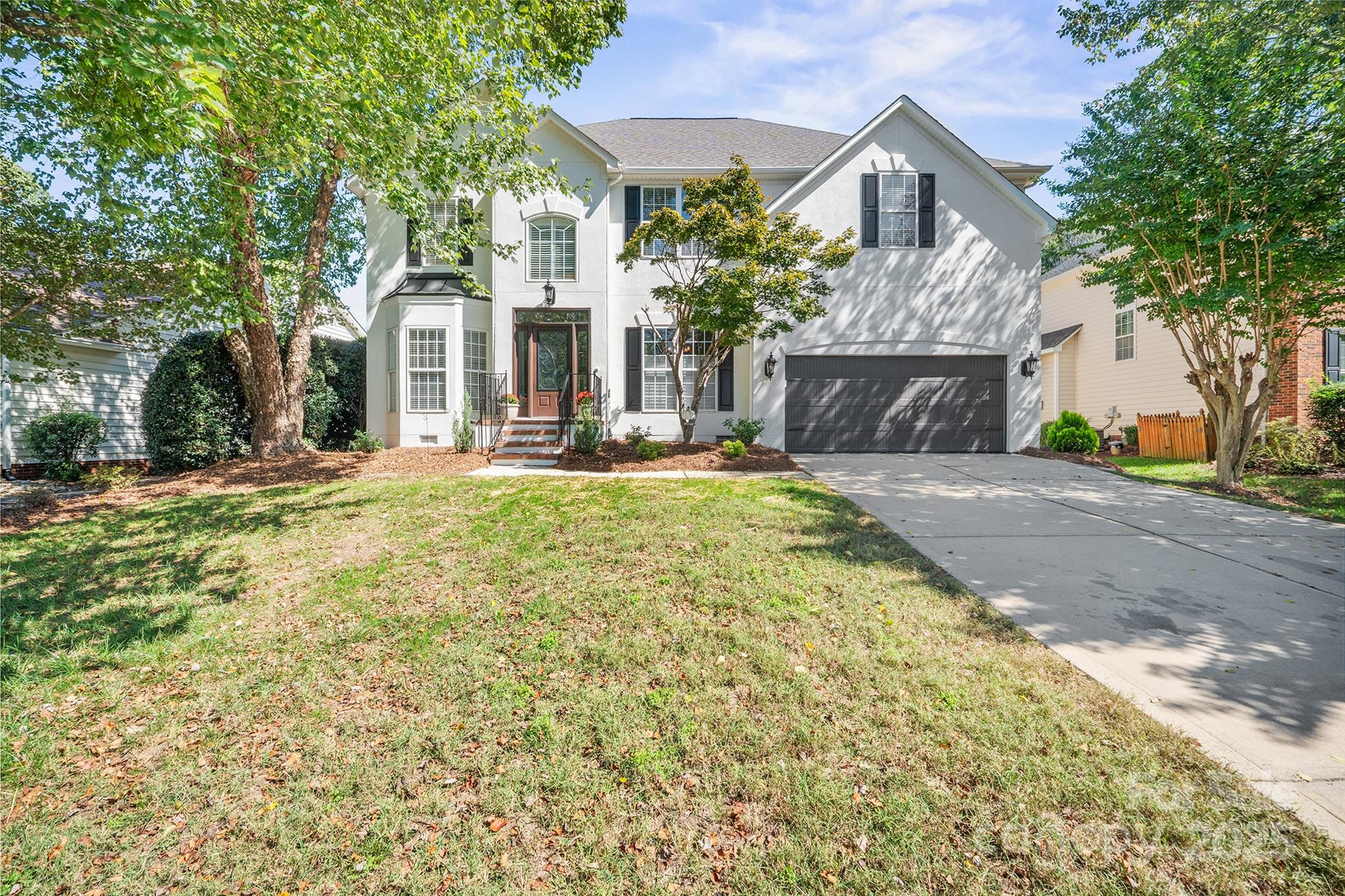 a front view of a house with a yard garage and outdoor seating