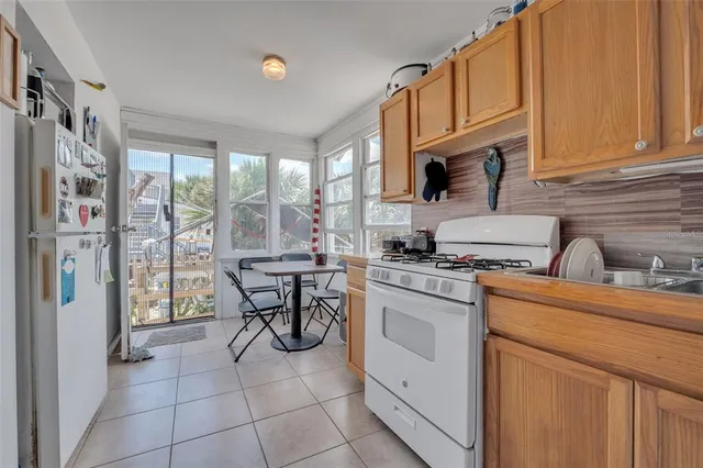a dining room with furniture a chandelier and wooden floor