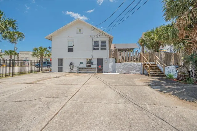 a view of a patio with table and chairs and potted plants