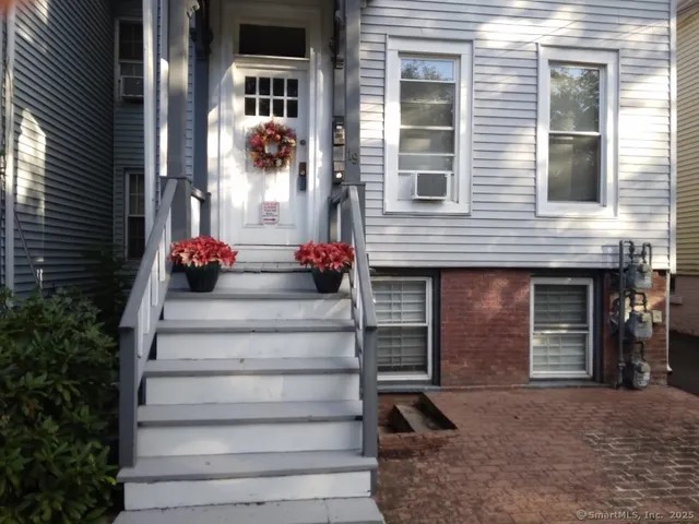 a front view of a house with potted plants