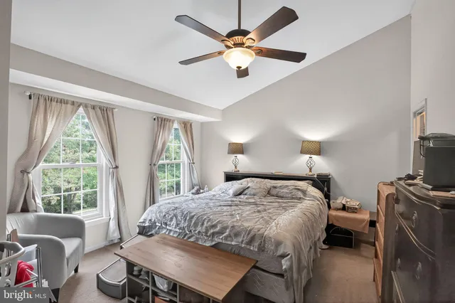 a bedroom with a bed a window and a chandelier