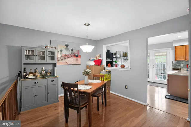 a view of a dining room with furniture wooden floor and a chandelier