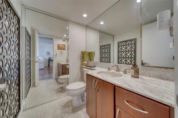 a bedroom with a bed a flat screen tv and a large window