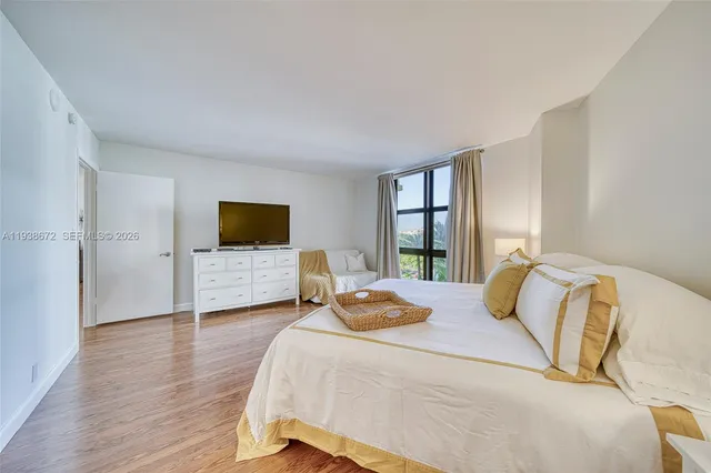 a bedroom with a bed and a large window