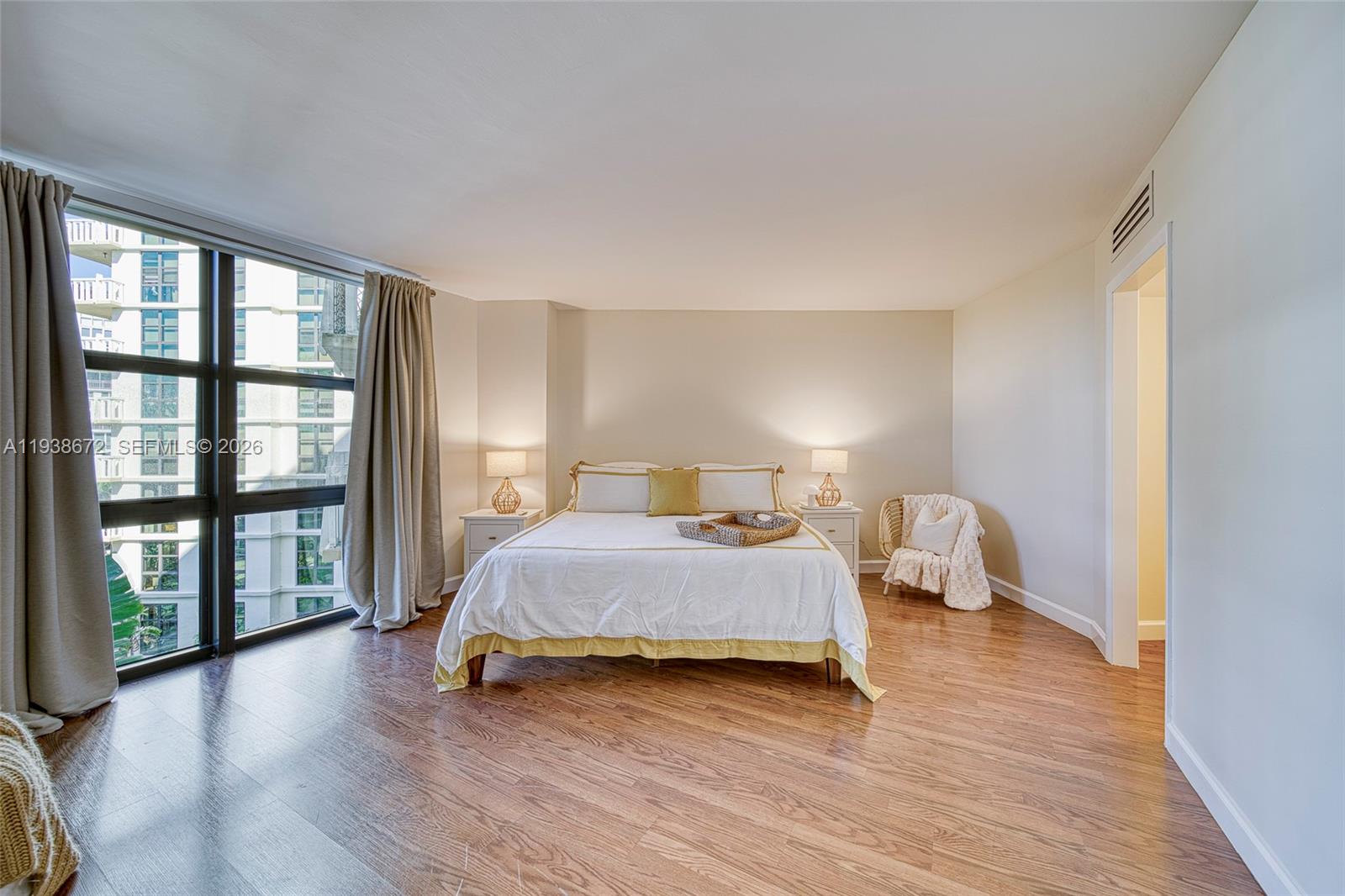 1111 Crandon Boulevard, Unit C404 Key Biscayne, FL 33149 - Photo 17 of 44 a bedroom with a bed and a large window