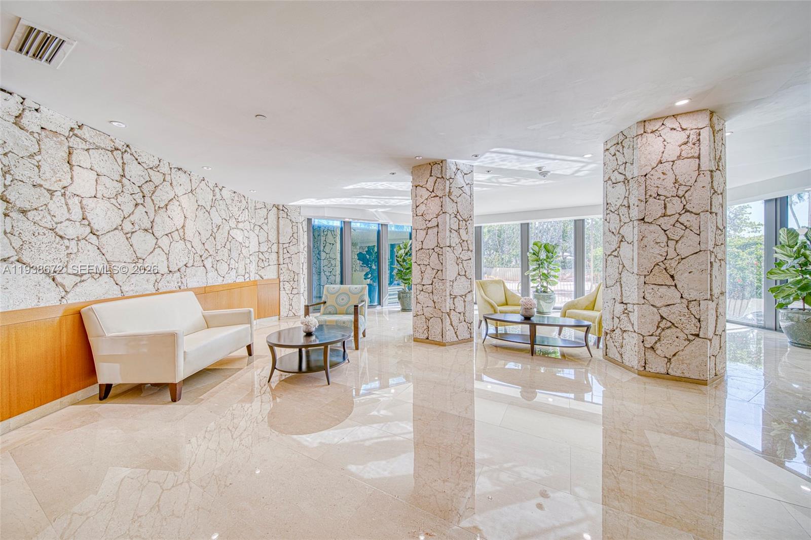 1111 Crandon Boulevard, Unit C404 Key Biscayne, FL 33149 - Photo 25 of 44 a living room with furniture and a floor to ceiling window