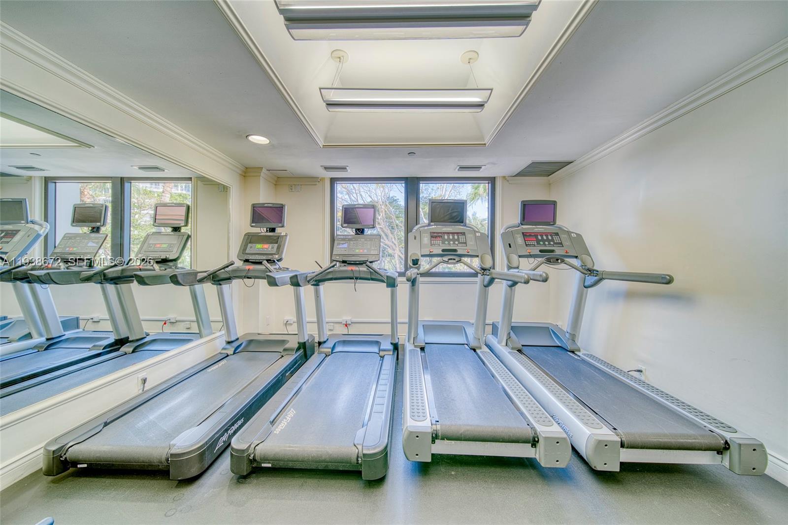 1111 Crandon Boulevard, Unit C404 Key Biscayne, FL 33149 - Photo 28 of 44 a room with gym equipment and large windows
