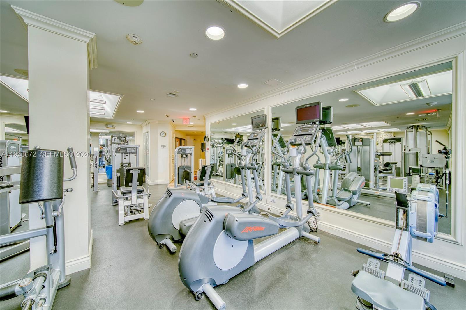 1111 Crandon Boulevard, Unit C404 Key Biscayne, FL 33149 - Photo 29 of 44 a room with gym equipment and a large window